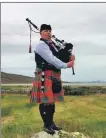  ?? ?? Pipe Major John Hunt, on Piper’s Rock with the sands of Loch Stornoway in the distance, has composed a signature tune for the building and the charitable trust which bought it.