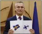  ?? JOHANNA GERON ?? NATO Secretary-General Jens Stoltenber­g displays documents as Sweden and Finland applied for membership in Brussels, Belgium, on Wednesday.