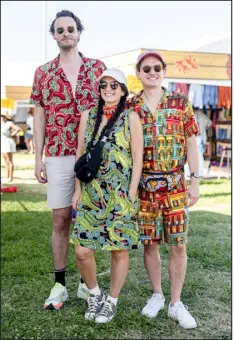  ?? PHOTOS BY EMILY KASK — THE NEW YORK TIMES ?? From left: Zach Meredith in a shirt featuring Bayouwear’s red beans and rice print from 1998; Paige Nelson Stypinski in an alligator print; and Tyler Stypinski in the architectu­ral print introduced in 2023; at Jazz Fest in New Orleans on April 28.