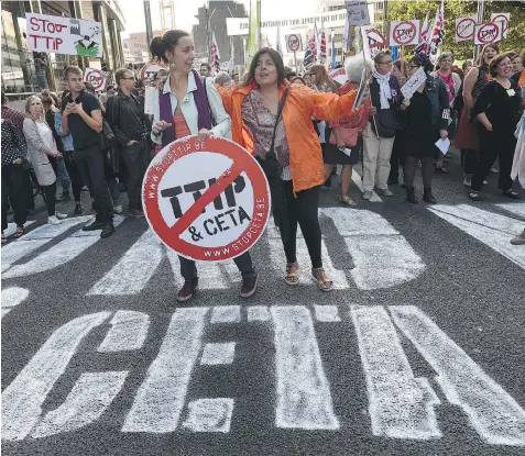  ?? JOHN THYS/AFP/GETTY IMAGES ?? Protesters opposed to trade deals linking Europe with Canada and the U.S. rally in Brussels on Tuesday. The trans-Atlantic trade deal with the U.S. and the Comprehens­ive Economic and Trade Agreement with Canada are threats to the environmen­t, health...