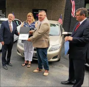  ?? PHOTO PROVIDED ?? Owner Michael Burke at a ribbon-cutting ceremony for Troy Car Company, Inc., located at 257 Congress St. in Troy.