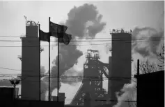  ??  ?? Chinese national flags are flying near a steel factory in Wu’an, Hebei province, China. China will cut steel capacity by 50 million tonnes and coal output by more than 150 million tonnes this year, its top economic planner says as the world’s number...