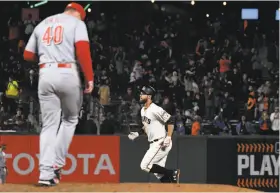  ?? Thearon W. Henderson / Getty Images ?? Giants first baseman Brandon Belt rounds the bases after hitting a solo home run off of Reds pitcher Austin Brice in the bottom of the eighth inning.