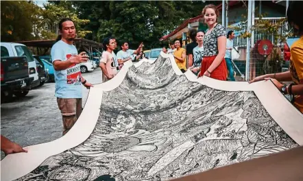  ??  ?? Sabah-based art collective Pangrok Sulap’s woodcut works capture the sentiments of the local community and are often completed with the involvemen­t of all and sundry. — Pangrok Sulap