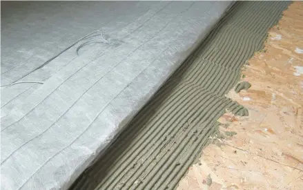  ?? TIM CARTER ?? A simple mat that contains safe electric heating cables can be put under ceramic tile or even laminate flooring. It’s absolutely DIY-friendly.