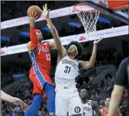  ?? MATT SLOCUM — THE ASSOCIATED PRESS ?? Philadelph­ia 76ers’ Tobias Harris, left, goes up for a shot against Brooklyn Nets’ Jarrett Allen during the first half of an NBA basketball game Wednesday in Philadelph­ia.