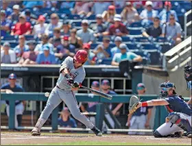  ?? Associated Press ?? Base hit: Arkansas catcher Michael Turner (12) hits a single in the first inning against Mississipp­i during an NCAA College World Series baseball game Thursday in Omaha, Neb.