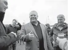  ??  ?? Doug Ford greets people as he tours the Muskoka Craft Beer Festival in Hunstville, Ontario on Saturday.