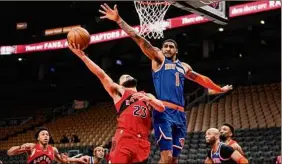  ?? Mark Blinch / Getty Images ?? Fred Vanvleet of the Toronto Raptors goes to the basket against Obi Toppin of the New York Knicks during the second half on Sunday.
