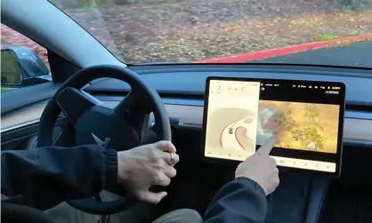  ?? Photograph: Gillian Flaccus/AP ?? A feature called “Passenger Play” allowed video games to be played on Tesla vehicles’ center touch screens while the car is in motion.