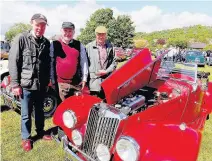  ?? 150517SUNI_08 ?? Expert eyes Taking a look under the bonnet of this MG sports car are Harry Henderson, Jan Targosz and Mike Tinson