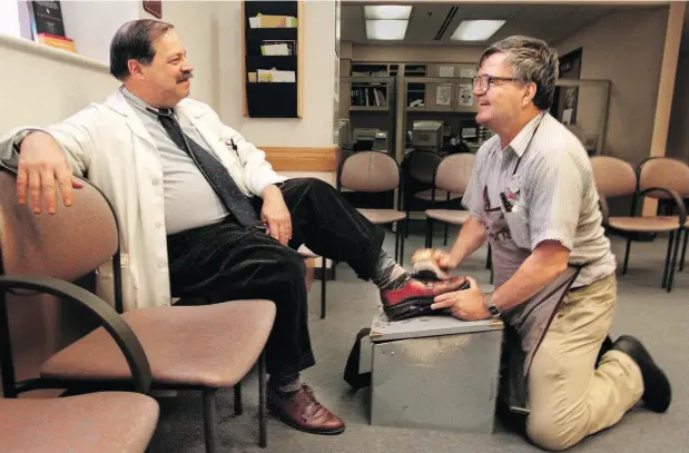  ?? BILL WADE / PITTSBURGH POST-GAZETTE VIA THE ASSOCIATED PRESS ?? Dr. Samuel Kocoshis, left, says his oxford shoes had a standing Friday date with Albert Lexie during the 1980s and ’90s at the UPMC Children’s Hospital of Pittsburgh. “He was quite an inspiratio­nal human being,” Kocoshis said.