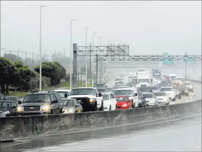  ?? Mike Stocker ?? The Associated Press Northbound traffic on the turnpike near Sunrise Boulevard is backed up in the rain as motorists prepare for Hurricane Irma on Thursday in Sunrise, Fla. Irma cut a path of devastatio­n across the northern Caribbean, leaving thousands...