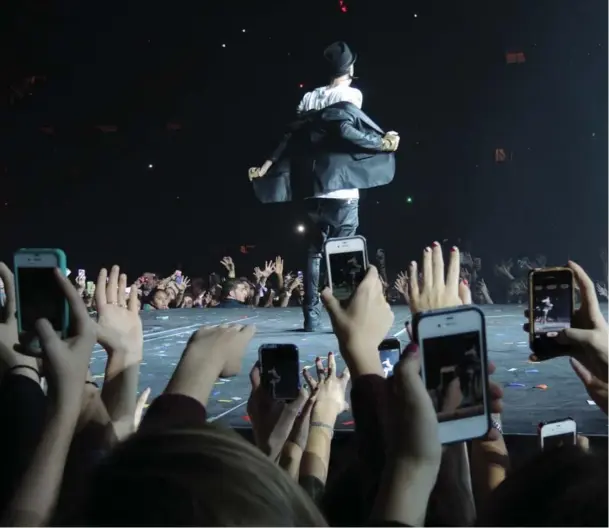  ??  ?? Fans use their smartphone­s to photograph and record video of Justin Bieber performing at Madison Square Garden in New York on Thursday. Bieber’s 125-date world tour makes its stop in Toronto on