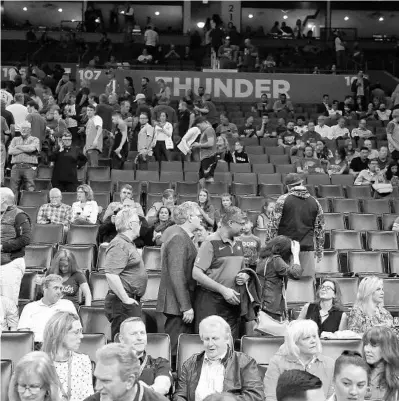  ?? KYLE PHILLIPS/AP ?? Basketball fans clear out after it is announced that the game between the Thunder and the Utah Jazz in Oklahoma City had been postponed on Wednesday night.