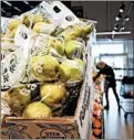  ??  ?? A bag of organic pears is displayed Nov. 14 as Robyn Wojo shops for produce.