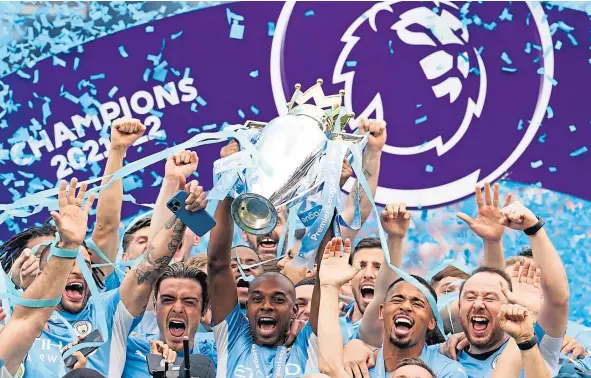  ?? ?? Fernandinh­o lifts the Premier League trophy after Manchester City came from behind to beat Aston Villa at the Etihad Stadium.