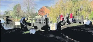  ??  ?? ●● The ramblers taking an afternoon break at the lock on the Trent and Mersey Canal at Thurlwood