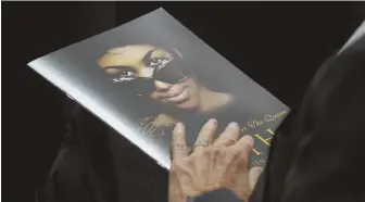  ?? AP Photo ?? HEIRS SINGING THE BLUES: A person holds a program during the funeral service for Aretha Franklin at Greater Grace Temple in Detroit on Friday. Franklin left no will.