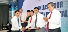  ?? ?? M.N.Gunathilak­a, winner of team leader category and sales force category of General Champions 2018 receiving awards from the Executive Director of SLIC Dushyantha B. Basnayake