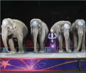  ?? PHOTOS BY BILL SIKES — THE ASSOCIATED PRESS ?? Asian elephants perform for the final time in the Ringling Bros. and Barnum &amp; Bailey Circus Sunday in Providence, R.I. The circus closes its own chapter on a controvers­ial practice that has entertaine­d audiences since circuses began in America two centuries ago. The animals will live at the Ringling Bros. 200-acre Center for Elephant Conservati­on in Florida.