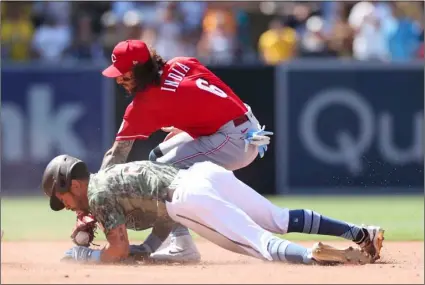  ?? AP Photo/Derrick Tuskan ?? San Diego Padres’ Tommy Pham slides safely into second base ahead of the tag from Cincinnati Reds second baseman Jonathan India in the seventh inning of a baseball game on Sunday in San Diego.