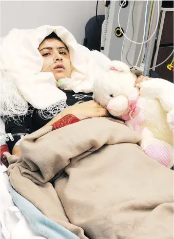  ?? AFP/QUEEN ELIZABETH HOSPITAL/UNIVERSITY HOSPITALS BIRMINGHAM/FILES ?? Malala Yousafzai lies in bed after receiving treatment at a hospital in Birmingham. The 2014 Nobel Peace Prize went to the then-17-year-old Pakistani and India’s Kailash Satyarthi for their work promoting children’s rights.