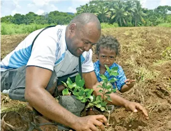  ?? Photo: Ministry of Agricultur­e ?? Mr James Allen plants a lemon tree as part of the Ridge to Reef (R2R) programme after receiving his offer letter from the Ministry of Agricultur­e.