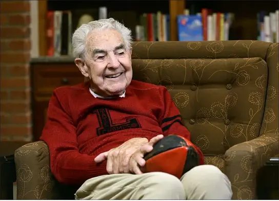  ?? JENNY SPARKS — LOVELAND REPORTER-HERALD ?? Wearing his high school letter sweater, Ken Calkins reminisces Thursday about being on the 1942Lovela­nd High School championsh­ip football team.