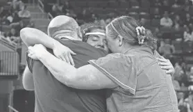  ?? ?? Central’s Liliana Alicea hugs her mother, right, and father, left, after she won the state 185-pound championsh­ip.