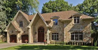  ?? MICHAEL SOBOCAN PHOTOS/SUTTON GROUP REALTY SYSTEMS INC. ?? This two-storey home features a stone façade, a double-entry door and an interlocki­ng stone walkway.