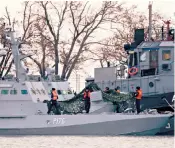  ??  ?? Nikol gunboat and Yana Kapu tug boat, of the Ukrainian navy, seized by Russians. The escalating tension has led to nationalis­ts lighting flares in a rally outside the Ukrainian parliament in Kiev. Hundreds of protesters brandished yellow-and-blue flags