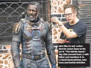  ??  ?? Idris Elba (l.) and writer/ director James Gunn on the set of “The Suicide Squad.” Top, Elba (second from r.) with fellow cast members (l. to r.) David Dastmalchi­an, John Cena and Daniela Melchior.