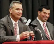  ?? JAY LAPRETE — THE ASSOCIATED PRESS ?? Ohio State NCAA college football head coach Urban Meyer, left, answers questions during a news conference announcing his retirement Tuesday in Columbus, Ohio. At right is assistant coach Ryan Day.