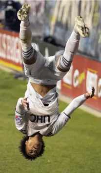  ?? GETTY ImaGES ?? FLIPPING PHILLY: Revolution forward Tajon Buchanan sticks a double back flip to celebrate his goal against the Philadelph­ia Union on Tuesday night in Chester, Pa.