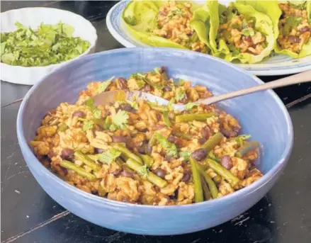  ?? GRETCHEN MCKAY/PITTSBURGH POST-GAZETTE ?? Mark Bittman’s take on Ma Po, a Sichuan dish featuring tofu in a spicy sauce, is made with ground chicken, green beans and Sichuan peppercorn­s for heat.