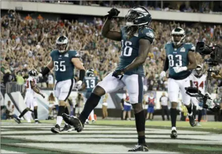  ?? MICHAEL PEREZ — ASSOCIATED PRESS ?? The Eagles’ Jay Ajayi celebrates after scoring a touchdown during the second half against the Atlanta Falcons on Thursday. The Birds survived in the final seconds when a throw by Exton native Matt Ryan sailed out of the end zone to complete the Eagles’ win.
