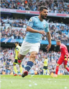  ?? — THE ASSOCIATED PRESS ?? Manchester City’s Sergio Aguero celebrates after scoring his team’s third goal of the game in a 6-1 demolition of Huddersfie­ld on Sunday.