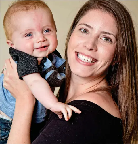  ??  ?? Above, he manages a smile with his mother Lydia