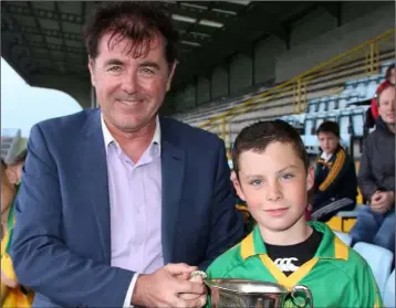  ??  ?? Blackwater captain Brian Og Curran receiving the cup from Jim Dempsey of the Rackard League.