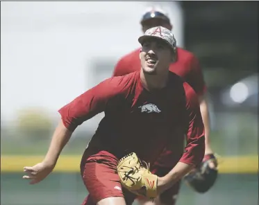  ?? NWA Democrat-Gazette/CHARLIE KAIJO ?? Arkansas’ Connor Noland catches throws during practice Sunday at the Bellevue East High School baseball field in Omaha, Neb.