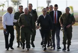  ?? (Amir Cohen/Reuters) ?? THEN-DEFENSE minister Ehud Barak (center) walks with Maj.-Gen. Yair Naveh, at the time the deputy chief of staff, during a visit to a military base near Kibbutz Re’im, outside the central Gaza Strip in 2012.