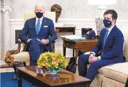  ?? ANDREW HARNIK AP ?? President Joe Biden and Transporta­tion Secretary Pete Buttigieg meet with members of the House on Thursday to discuss infrastruc­ture.