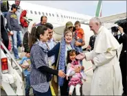  ??  ?? Pope Francis welcomes a group of Syrian refugees after landing at Ciampino airport in Rome following a visit at the Moria refugee camp in the Greek island of Lesbos last Saturday.