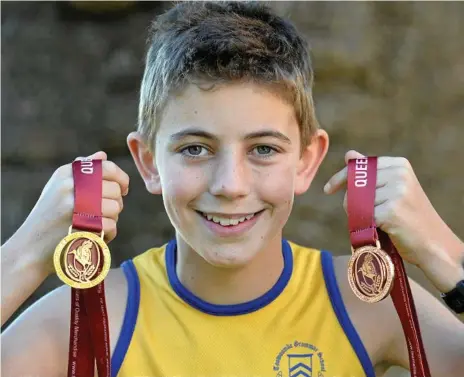  ?? Photo: Kevin Farmer ?? GOLDEN MOMENT: Toowoomba Grammar School student Charlie Randall defended his under-12 cross-country title at the Queensland championsh­ips. He also captained the Darling Downs relay team to third place at the championsh­ips.