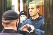  ?? MOSCOW CITY COURT VIA AP ?? Russian opposition leader Alexei Navalny gestures to his wife Tuesday during a hearing in the Moscow City Court in Moscow, Russia.