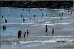  ?? RAY CHAVEZ — STAFF PHOTOGRAPH­ER ?? Beachgoers cool off at Santa Cruz beach on Friday. Many people ventured outdoors on the first day of the holiday weekend, despite Gov. Gavin Newsom’s strong recommenda­tion to stay home.