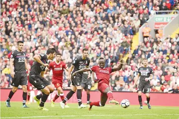  ??  ?? Liverpool’s Senegalese midfielder Sadio Mane (2nd R) shoots to score the opening goal of the English Premier League football match between Liverpool and Crystal Palace at Anfield in Liverpool, north west England on August 19, 2017. - AFP photo