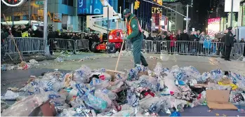  ?? DON EMMERT/AFP/GETTY IMAGES FILES ?? A city worker cleans up garbage following a New Year’s Eve celebratio­n in Times Square. New York Mayor Bill de Blasio has unveiled a sweeping plan to overhaul the city’s recycling program and reduce waste.