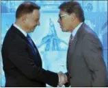  ?? CZAREK SOKOLOWSKI — THE ASSOCIATED PRESS ?? Poland’s President Andrzej Duda, left, and U.S. Energy Secretary Rick Perry, right, shake hands Thursday during a ceremony in Warsaw, Poland.